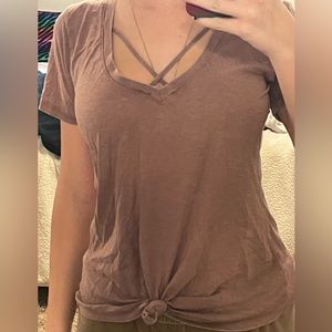 dusty pink t-shirt with tie in front and cross neck line. size XS